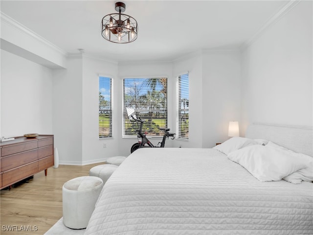 bedroom featuring baseboards, light wood finished floors, and ornamental molding