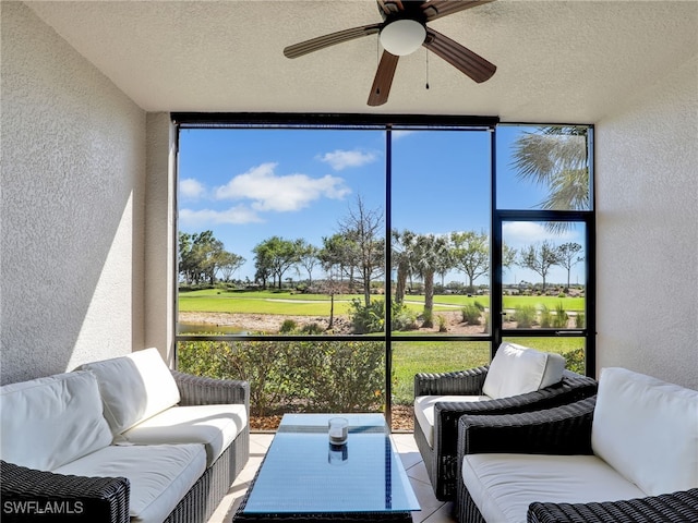 sunroom featuring ceiling fan