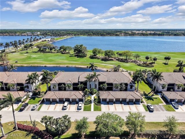 drone / aerial view with a residential view, a water view, and view of golf course