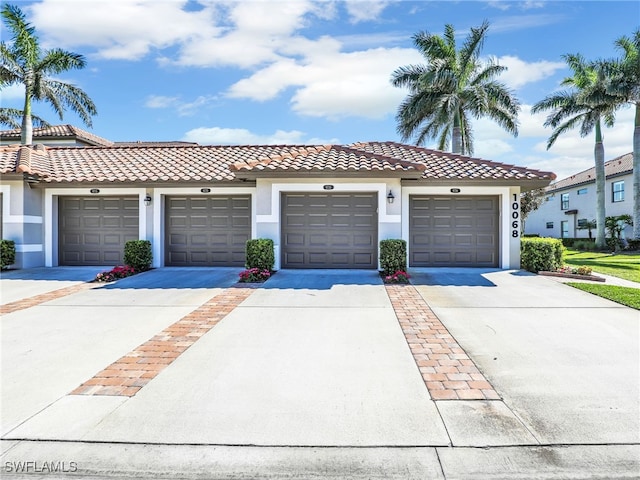 view of front of home with stucco siding and a tile roof