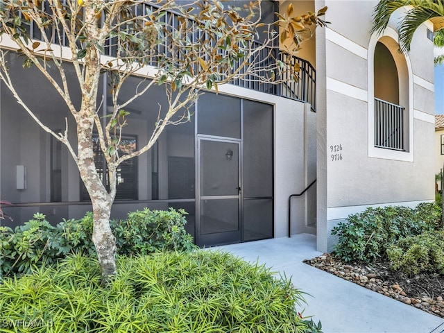 doorway to property with stucco siding