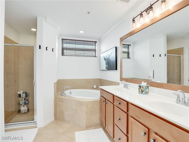 bathroom featuring double vanity, a stall shower, a sink, tile patterned flooring, and a bath