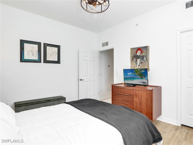 bedroom featuring visible vents and light wood-style flooring