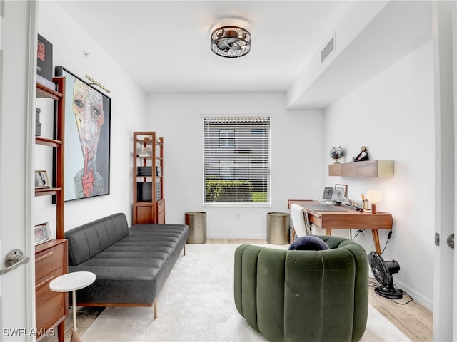 home office with wood finished floors, baseboards, and visible vents