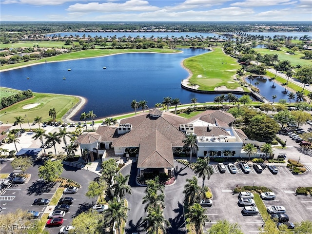 birds eye view of property featuring view of golf course and a water view