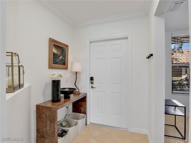 entryway with light tile patterned floors, visible vents, and crown molding