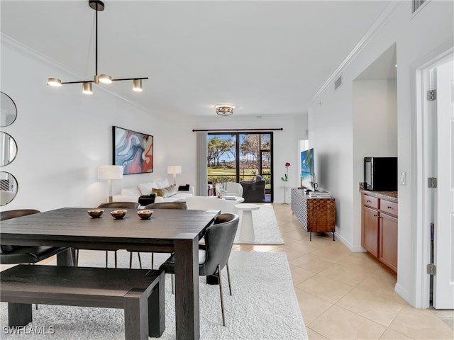 dining space featuring crown molding, light tile patterned floors, baseboards, and visible vents