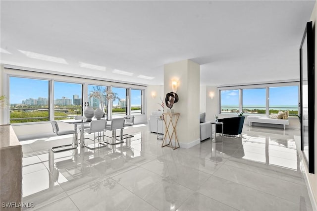 dining area with baseboards and a city view