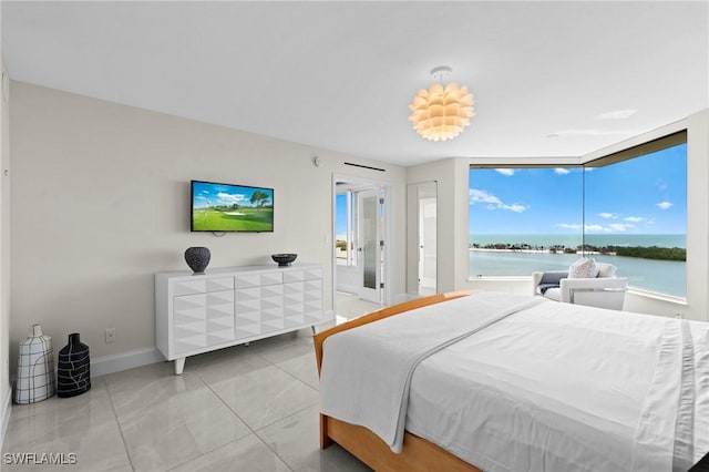 bedroom with tile patterned floors, baseboards, and access to exterior