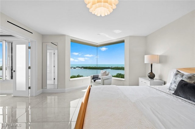 bedroom with baseboards, a water view, and an inviting chandelier