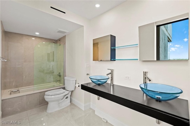 bathroom with enclosed tub / shower combo, visible vents, toilet, and a sink