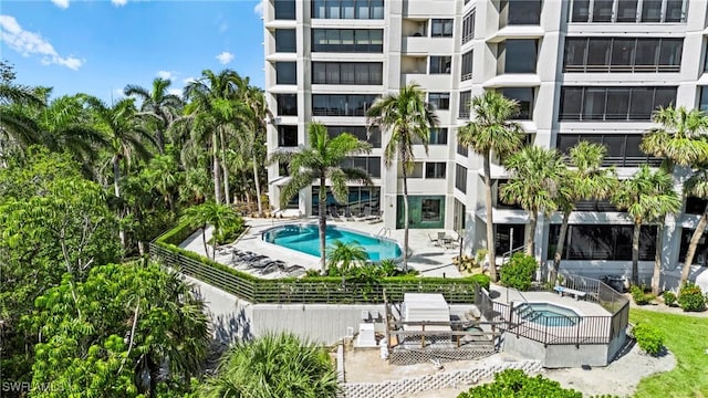 community pool featuring a patio area and a hot tub