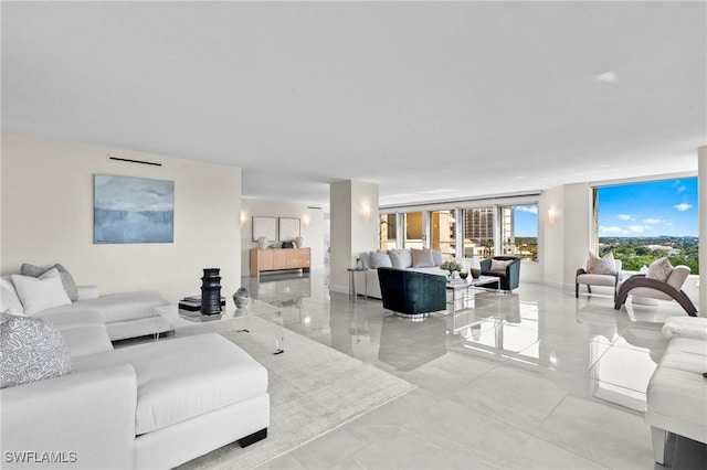 living area featuring a wall of windows and baseboards