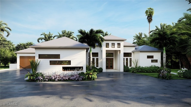 view of front facade featuring stucco siding, french doors, and a garage