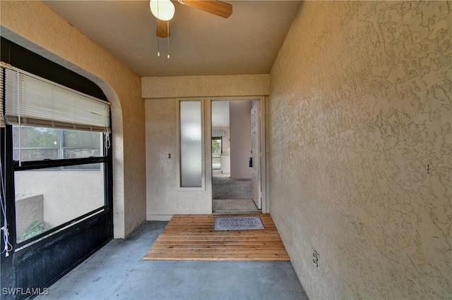 exterior space featuring stucco siding and a ceiling fan