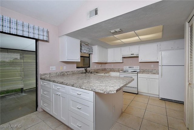 kitchen featuring white appliances, visible vents, a peninsula, a sink, and under cabinet range hood