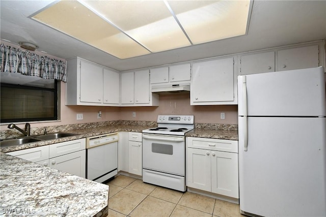 kitchen featuring white appliances, light tile patterned floors, a sink, under cabinet range hood, and white cabinetry