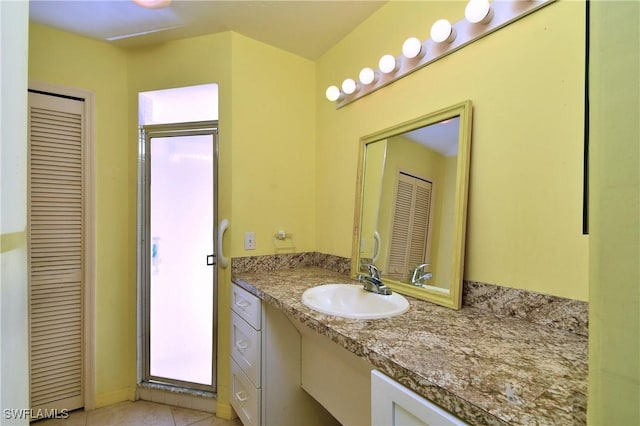 bathroom with a closet and vanity