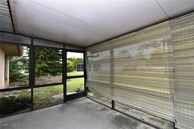 unfurnished sunroom with lofted ceiling