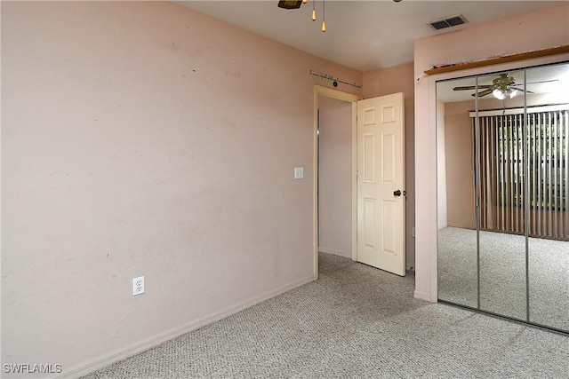 unfurnished bedroom featuring a closet, baseboards, visible vents, and carpet floors