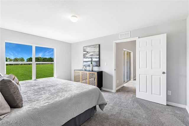 carpeted bedroom with baseboards and visible vents