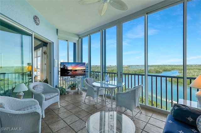 sunroom featuring expansive windows and stone tile floors