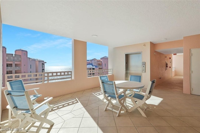 exterior space featuring a balcony and elevator