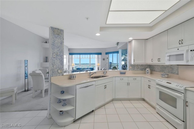 kitchen with light countertops, backsplash, a sink, open shelves, and white appliances