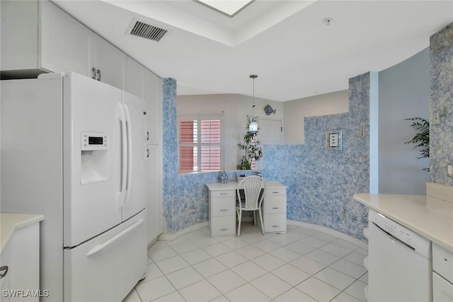 kitchen with light countertops, wallpapered walls, visible vents, and white appliances