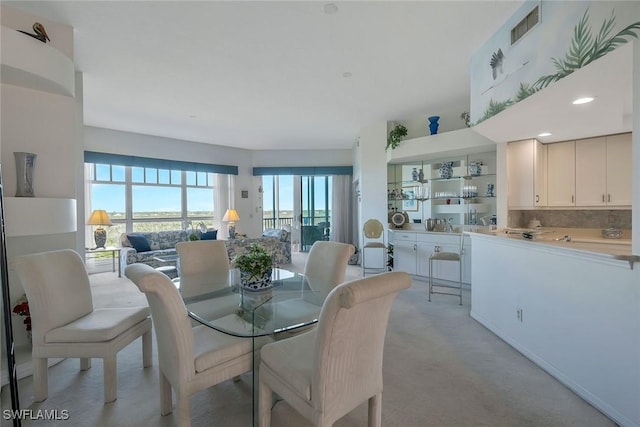 dining space with light colored carpet and visible vents
