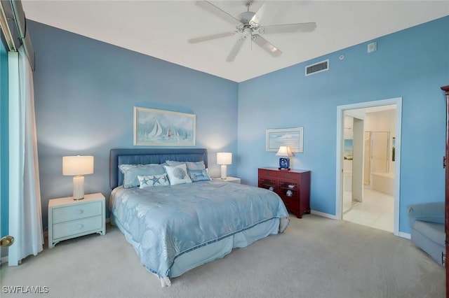 carpeted bedroom featuring baseboards, ensuite bath, visible vents, and a ceiling fan