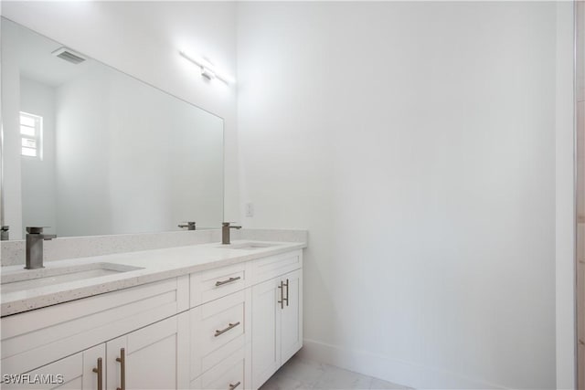 bathroom featuring double vanity, visible vents, marble finish floor, and a sink