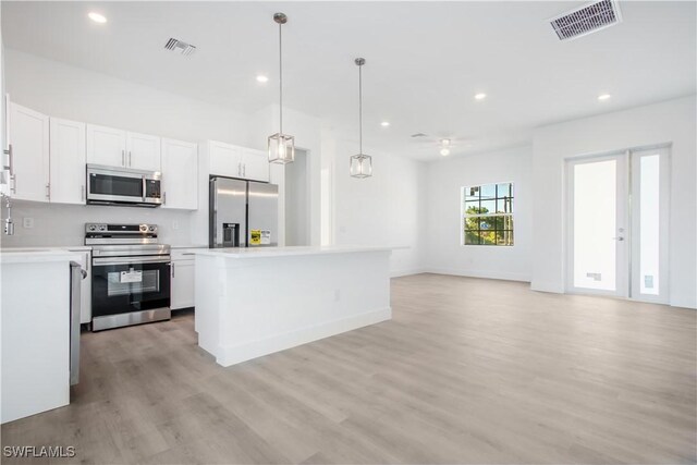 kitchen with white cabinetry, light wood-type flooring, visible vents, and appliances with stainless steel finishes