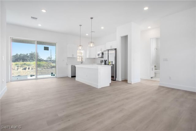 unfurnished living room featuring baseboards, recessed lighting, light wood finished floors, and visible vents