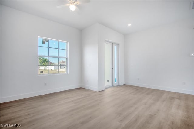 spare room featuring light wood-type flooring, visible vents, recessed lighting, a ceiling fan, and baseboards