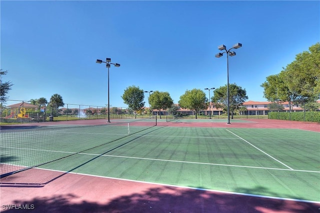 view of tennis court with fence