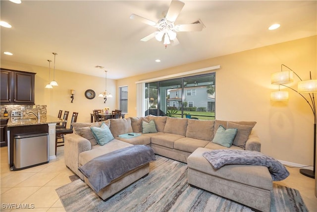 living room with light tile patterned flooring, recessed lighting, baseboards, and ceiling fan