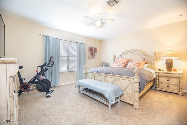 bedroom with ceiling fan, light colored carpet, visible vents, and baseboards