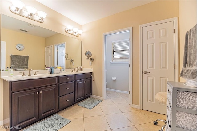 full bathroom with a sink, visible vents, double vanity, and tile patterned floors