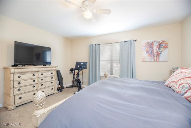 carpeted bedroom featuring a ceiling fan and baseboards