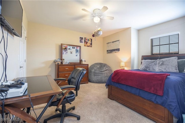 bedroom featuring light colored carpet and a ceiling fan