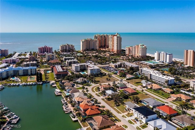 birds eye view of property with a city view and a water view