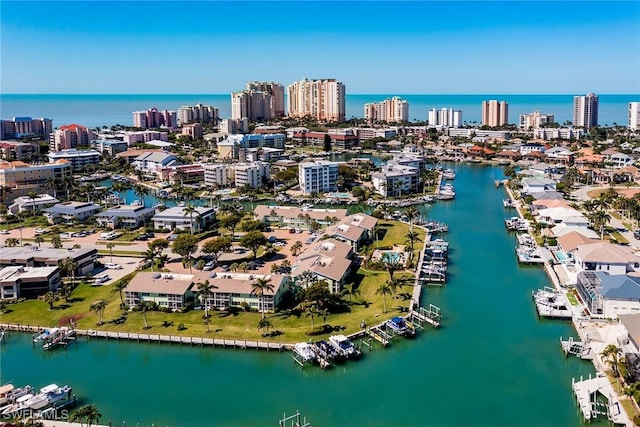 birds eye view of property featuring a water view and a city view