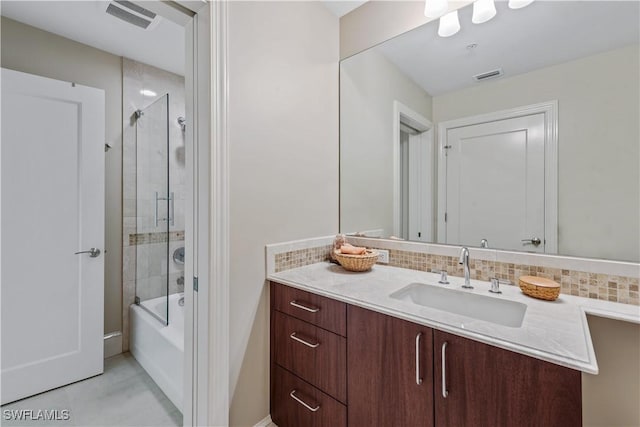 full bathroom with shower / bath combination with glass door, visible vents, backsplash, and vanity