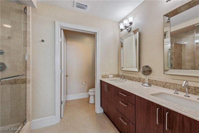 bathroom featuring visible vents, backsplash, and a sink