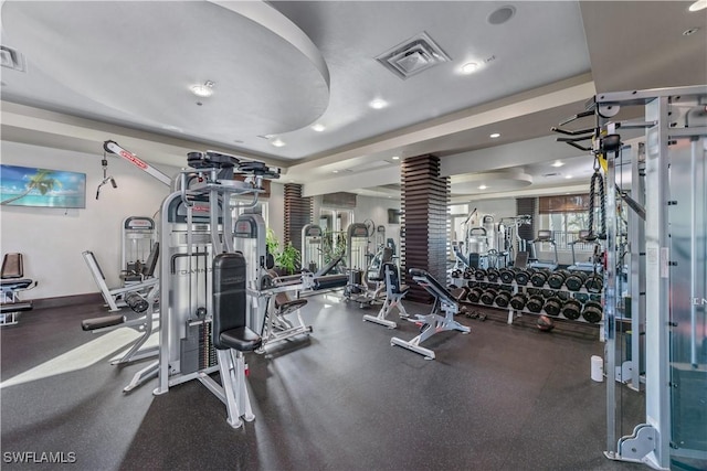 workout area featuring recessed lighting, baseboards, visible vents, and decorative columns