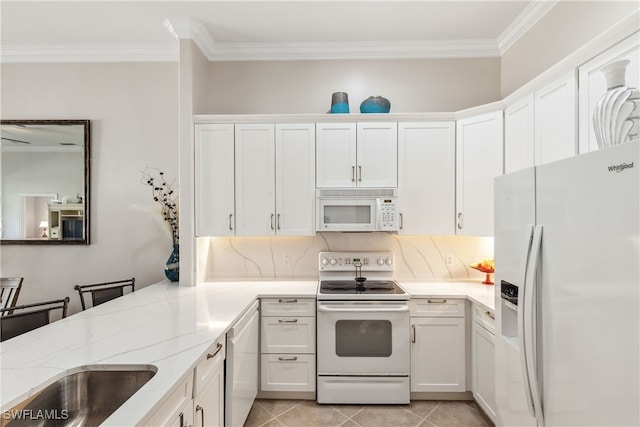 kitchen with ornamental molding, white cabinetry, white appliances, light tile patterned flooring, and light stone countertops