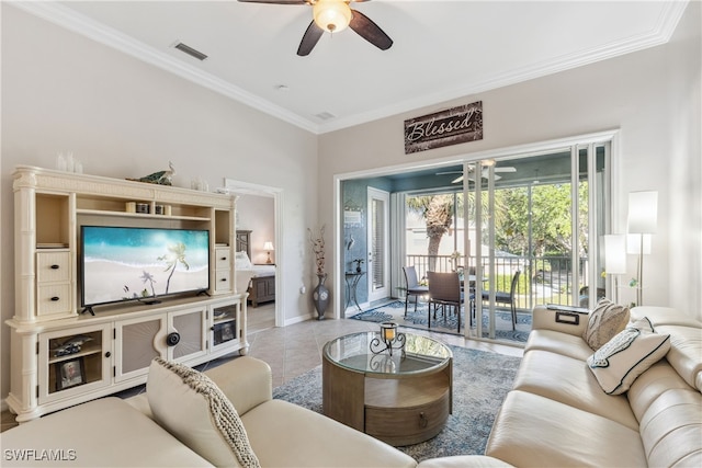 living area featuring light tile patterned floors, a ceiling fan, baseboards, visible vents, and ornamental molding