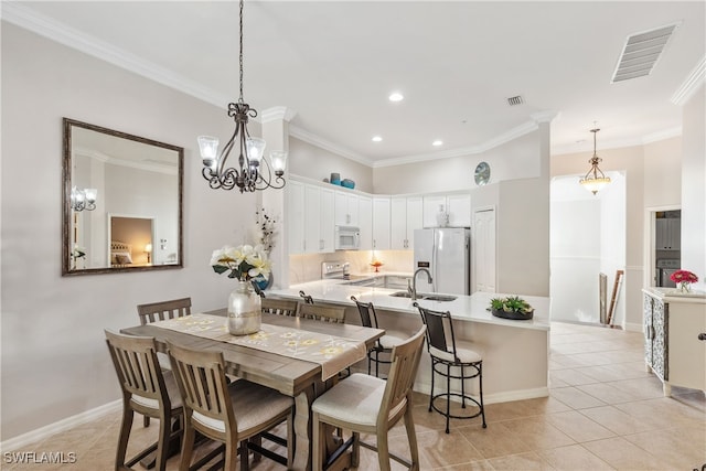 dining room featuring light tile patterned floors, visible vents, and crown molding