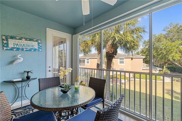 sunroom featuring a ceiling fan